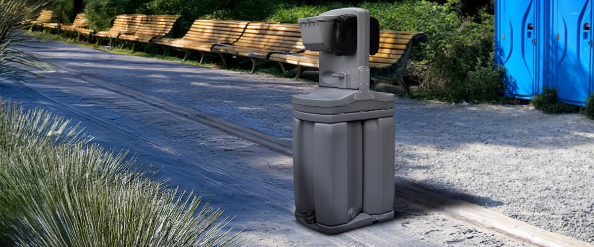 Portable hand washing station deployed on a job site next to portable restrooms